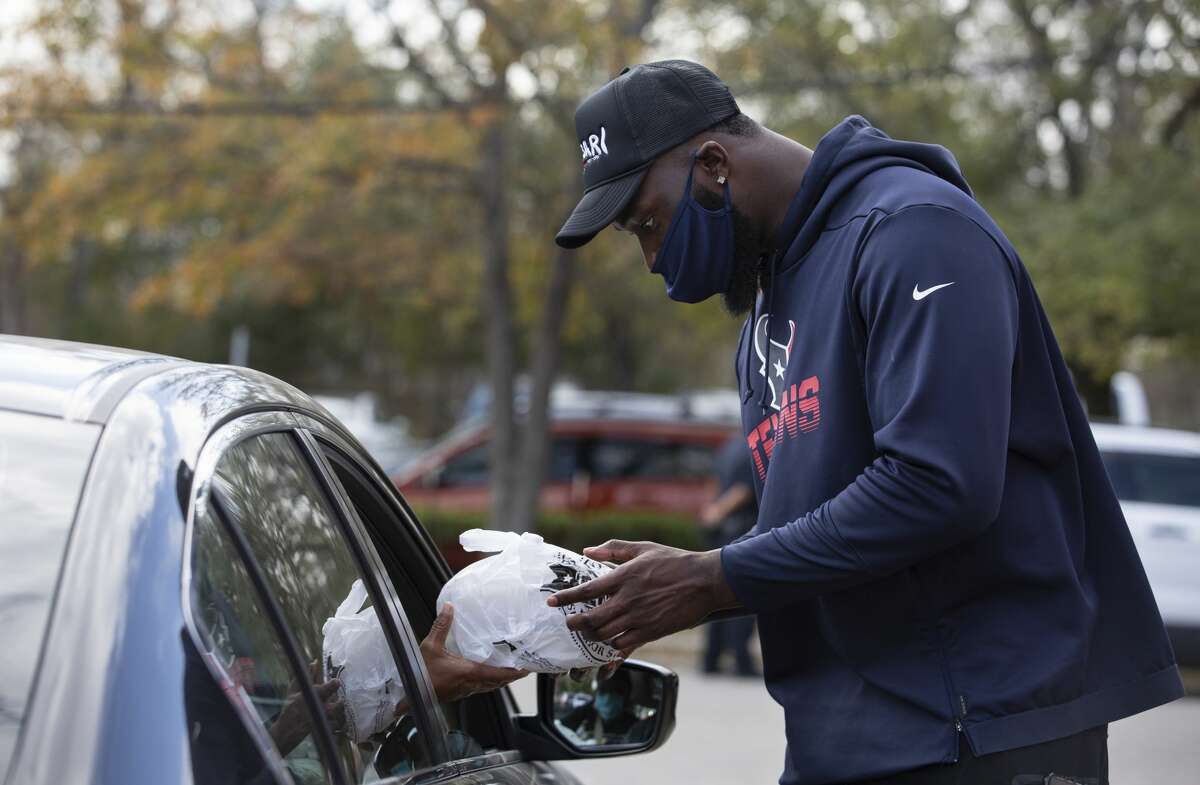 Houston Texans's Charles Omenihu helps distributing meals in Fifth Ward Monday, Jan. 18, 2021, at Pleasant Hill Missionary Baptist Church in Houston. Lucille's 1913 Conscious Community Collective distributed 1,000 meals in honor of Dr. Martin Luther King Jr.