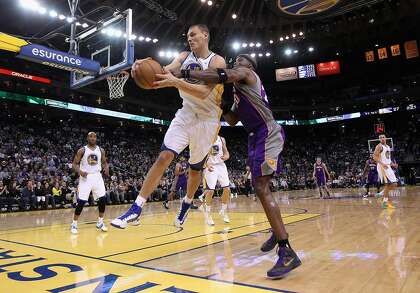 Andris Biedrins takes the ball from Jermaine O'Neal in 2013.