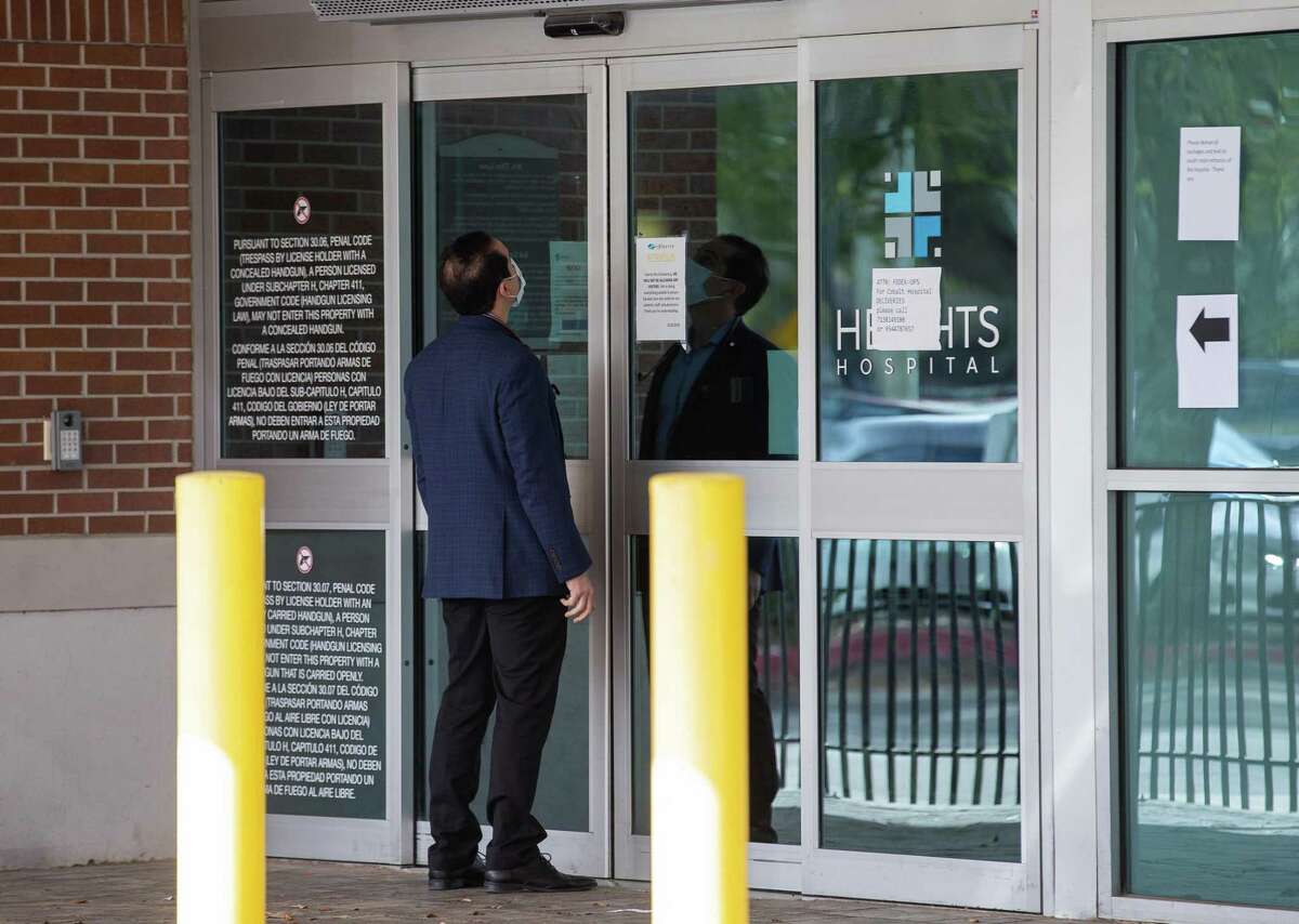 A doctor stands outside the Heights Hospital on Monday. Medical staff and patients were locked out without any notice.