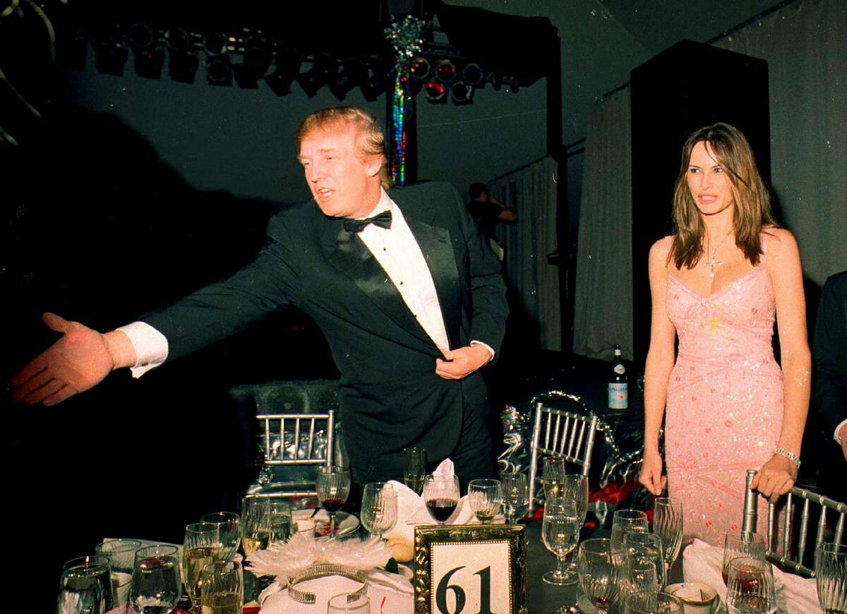 Donald Trump and his girlfriend (and future wife) Melania Knauss greet guests during a New Year's event at Mar-a-Lago on Dec. 31, 2000.