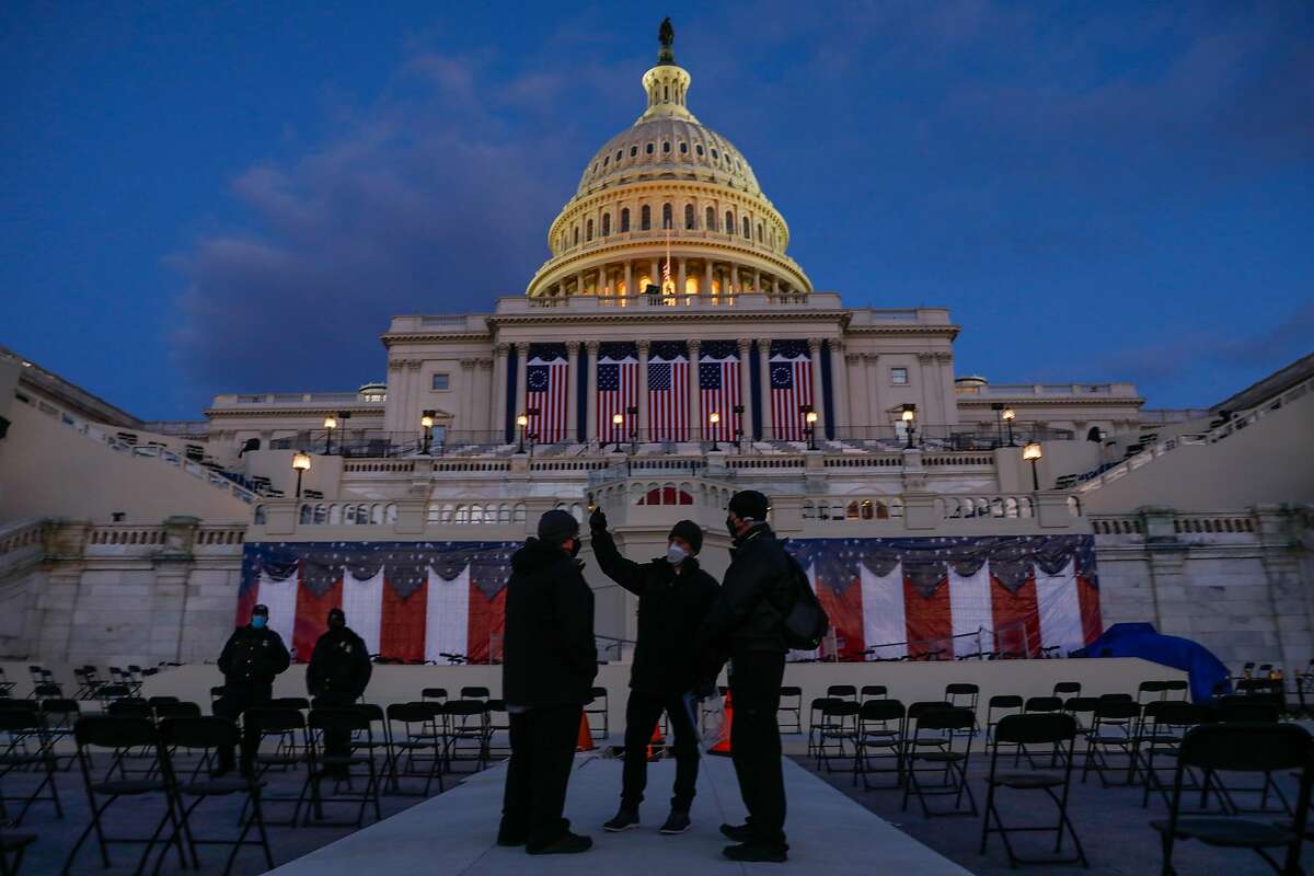 People talk outside the U.S. Capitol ahead of the Presidential Inauguration on Monday, Jan. 18, 2021 in Washington, D.C.