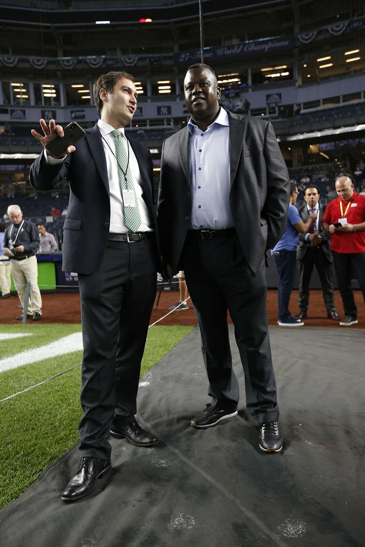 President David Kaval and Assistant General Manager/Director of Player Personnel Billy Owens of the Oakland Athletics talk on the field prior to the game against the New York Yankees in the American League Wild Card Game at Yankee Stadium on October 3, 2018 New York, New York. The Yankees defeated the Athletics 7-2.