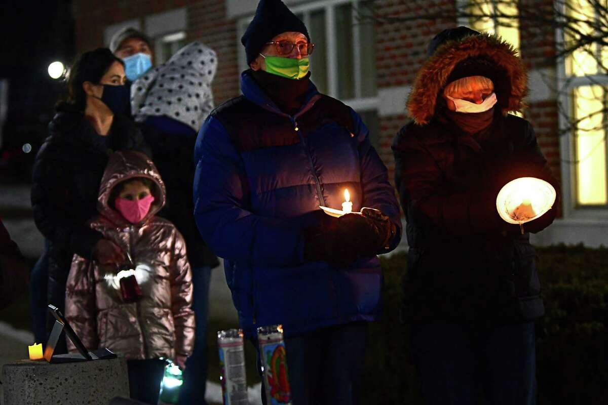 People participate in an inauguration eve COVID-19 memorial candlelight vigil outside Niskayuna Town Hall on Tuesday, Jan. 19, 2021 in Schenectady, N.Y. (Lori Van Buren/Times Union)