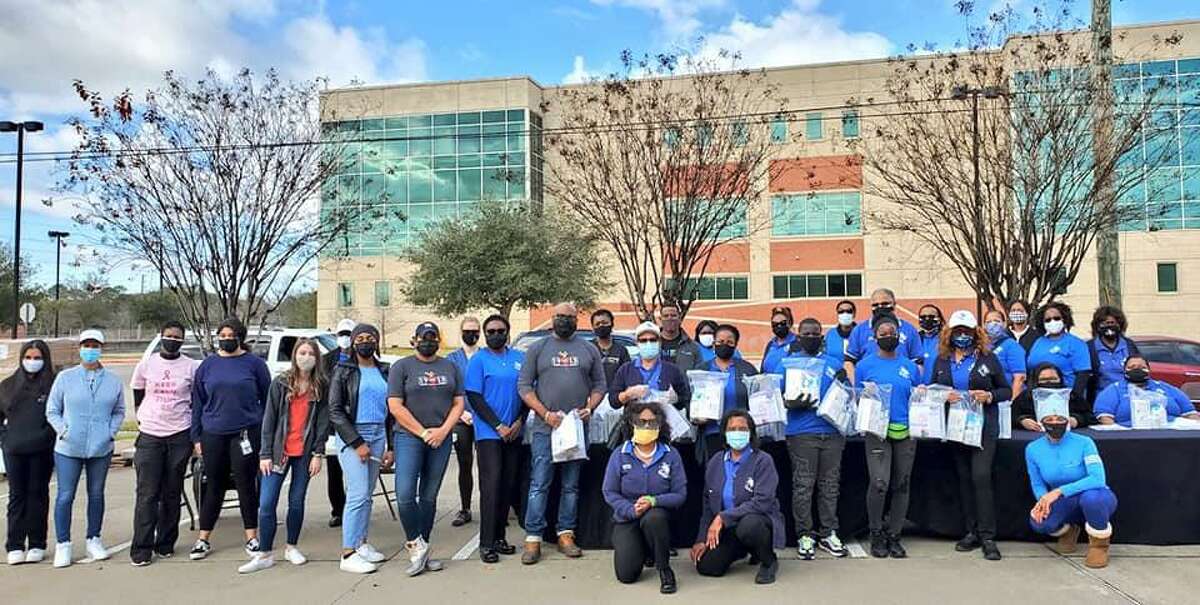 Volunteers from Lucille's 1913, Fort Bend County Black Nurses Association and MPACT Strategic Consulting in front of Gus George Academy in Richmond on MLK Day.