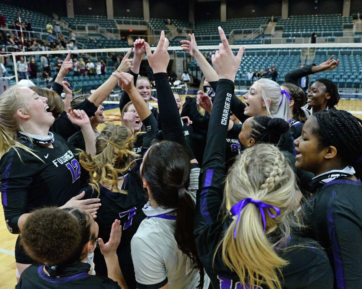 The Fulshear Chargers celebrate their 3-0 victory over the Dripping Springs Tigers in the Class 5A state semifinal volleyball match on Tuesday, December 8, 2020 at the Leonard Merrell Center, Katy, TX.