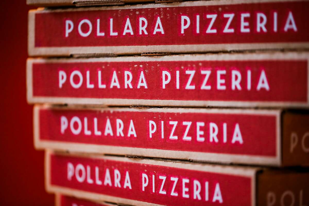 Pollara Pizzeria boxes rest on a shelf.