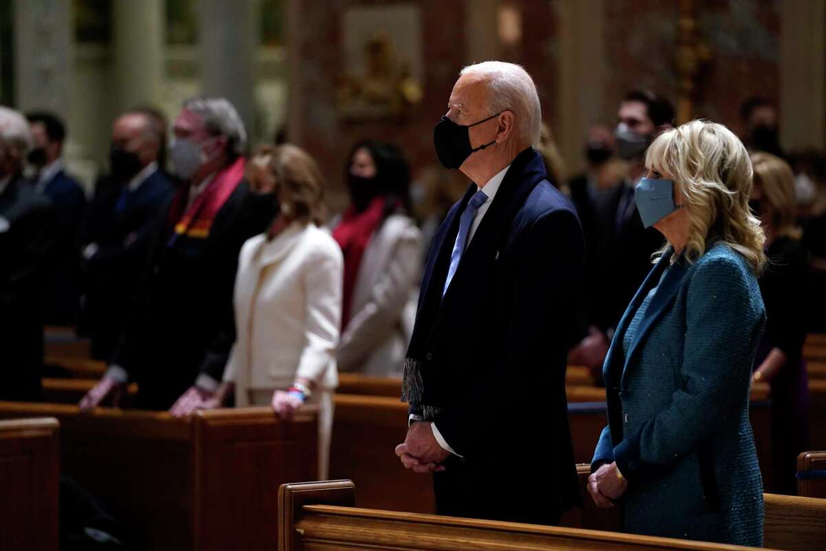 President-elect Joe Biden is joined his wife Jill Biden as they celebrate Mass at the Cathedral of St. Matthew the Apostle during Inauguration Day ceremonies Wednesday, Jan. 20, 2021, in Washington.