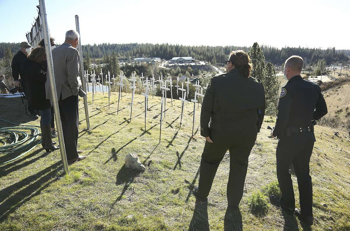 Nevada County Supervisor Dan Miller, Sheriff Moon, and Chief Alex Gammelgard were a few to pay their respects to those lives lost to the coronavirus in Nevada County Tuesday, Jan. 19, 2021 in Grass Valley, Calif. (Elias Funez/The Union via AP)