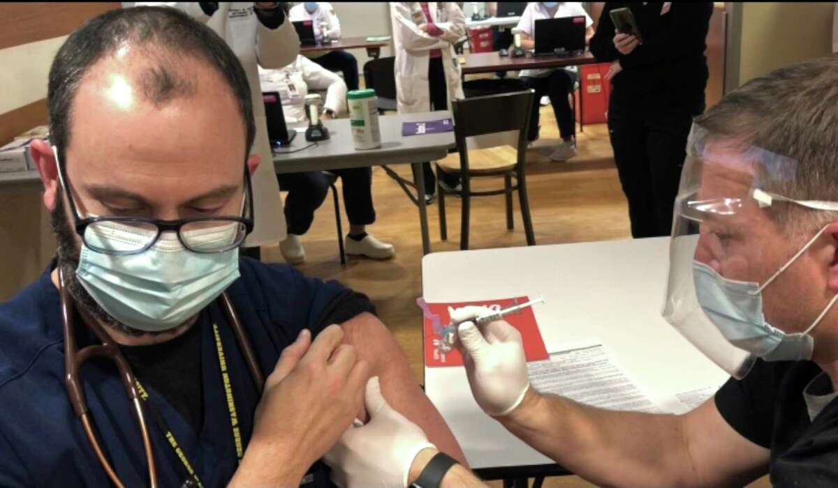 Dr. Guillermo Ballarino, pulmonary intensivist, gets the first COVID-19 vaccine at Danbury Hospital. Dr. Ballarino has been on the frontlines caring for patients since Danbury Hospital’s first COVID-19 patient in March.
