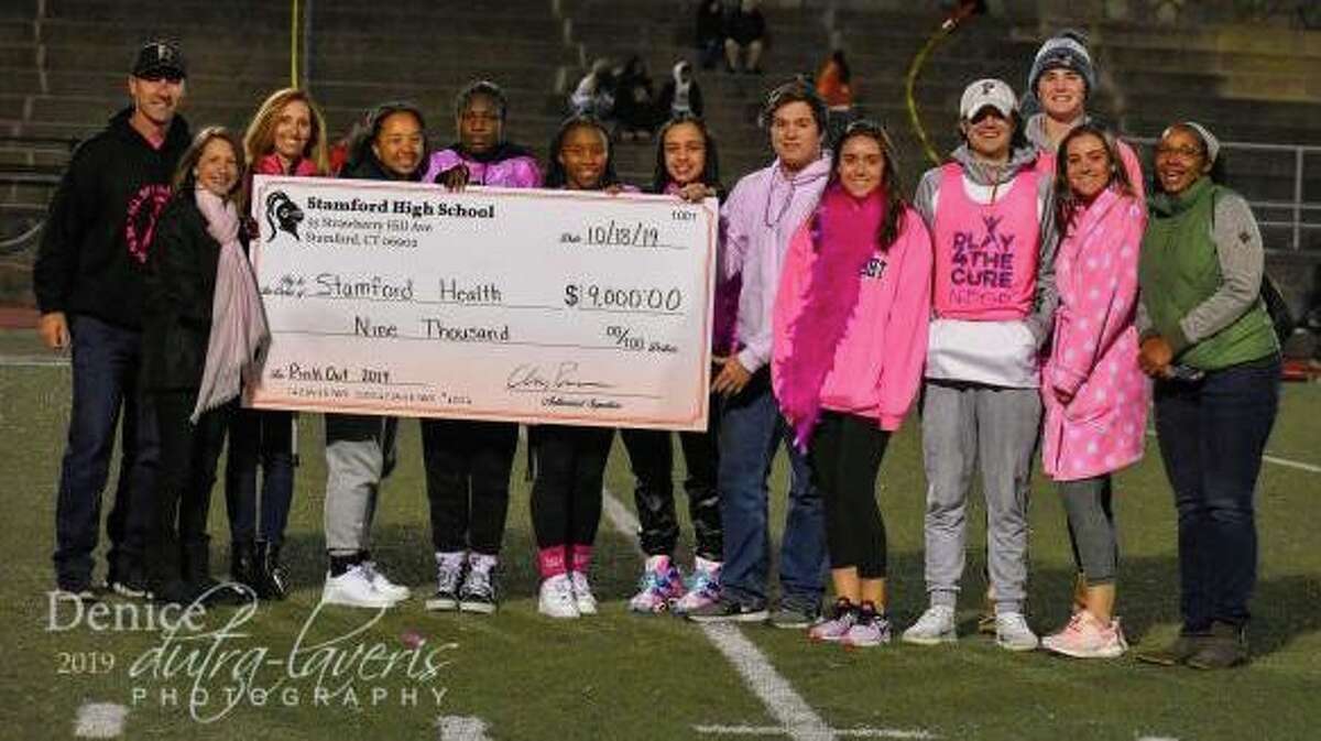 Stamford High students and staff presented Bennett Cancer Center Director of Development Gayle Alswanger a check for $9,000 in 2019.