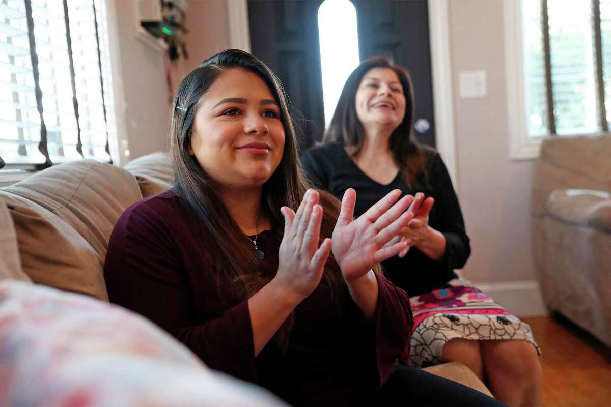 DACA recipient Vanessa Mejia and her mother, Connie, applaud from their living room in Oakland, Calif., as US Vice President Kamala Harris takes the oath of office at the US Capitol in Washington, DC on Wednesday, January 20, 2021.