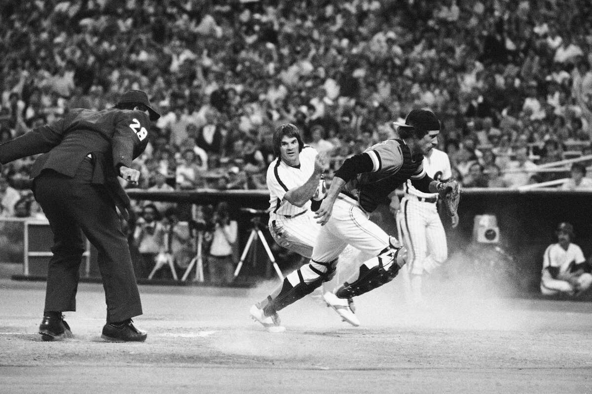 Phillies' Pete Rose turns as he crosses the plate to watches San Francisco Giants' catcher Mike Sadek chase down the ball that went by him in the first inning on Friday, July 7, 1979, game in Philadelphia. Rose scored on a single from second base as the Phillies won, 6-1.