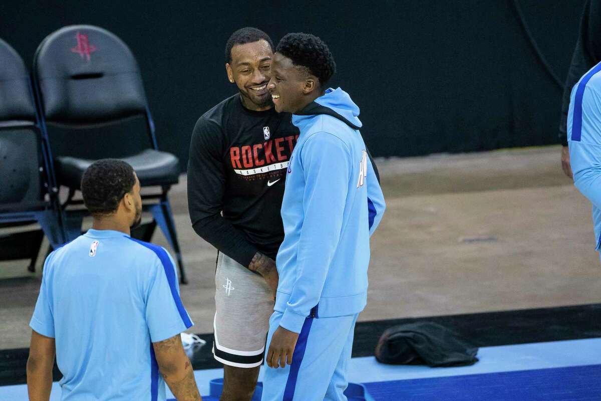 Houston Rockets guard John Wall (1) talks with Houston Rockets guard Victor Oladipo (7) before an NBA game between the Houston Rockets and Phoenix Suns on Wednesday, Jan. 20, 2021, at Toyota Center in Houston.