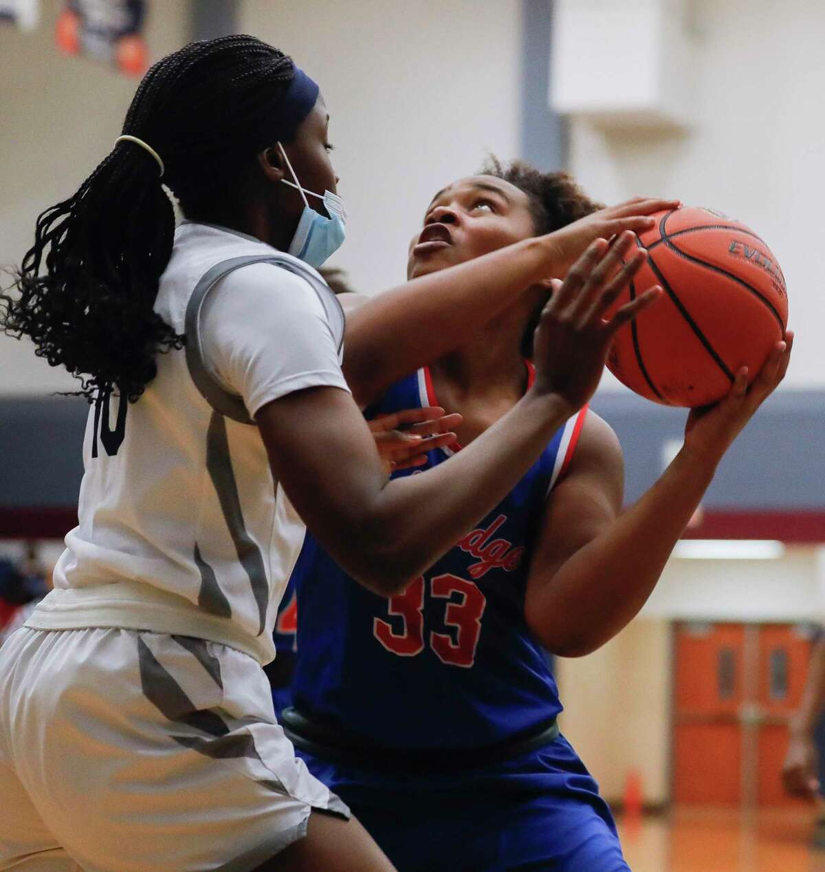 Oak Ridge center Raniyah Lewis (33) goes up for a basket against College Park power forward Ali Diop (10) during the first quarter of a District 15-6A high school basketball game at College Park High School, Wednesday, Jan. 20, 2021, in The Woodlands.