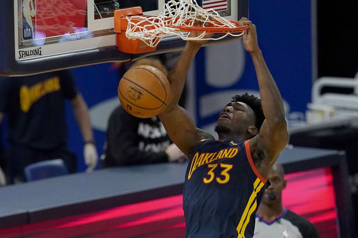 Golden State Warriors center James Wiseman (33) dunks against the San Antonio Spurs during the second half of an NBA basketball game in San Francisco, Wednesday, Jan. 20, 2021. (AP Photo/Jeff Chiu)