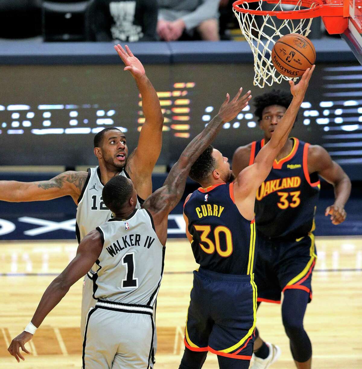 Stephen Curry (30) scores despite the double coverage in the first half as the Golden State Warriors played the San Antonio Spurs at Chase Center in San Francisco, Calif., on Wednesday, January 20, 2021.