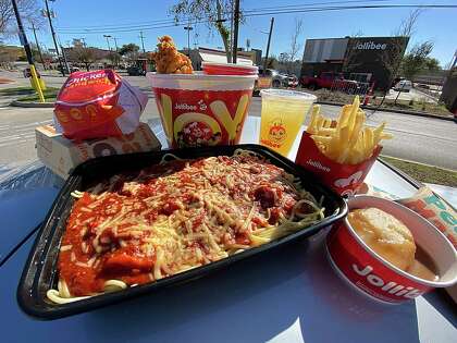 The menu at the Philippine fast-food chain Jollibee includes, clockwise from front, spaghetti, a crispy chicken sandwich, fried chicken, pineapple juice, fries, fried pies and mashed potatoes.