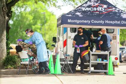 Paramedics from the Montgomery County Hospital District administer tests for COVID-19 outside a senior care facility on Thursday, May 14, 2020, at Focused Care at Beechnut in Houston.