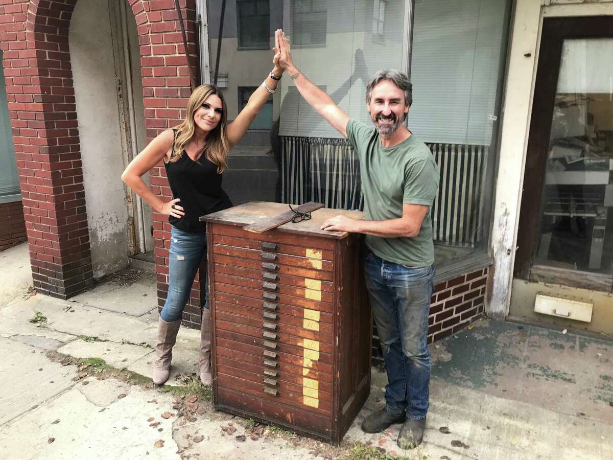 Norwalk resident Gloria Dillard high fives "American Pickers" host Mike Wolfe in front of the Hour Press building in Norwalk. “American Pickers” is a reality series that follows the two hosts, Mike Wolfe and Frank Fritz, as they travel across the nation searching for forgotten antiques. Nathan Dillard said he couldn’t reveal too much of what will air in the upcoming episode, noting, “Obviously, I want people to see the show,” before adding that he discusses his newspaper property and the antiques inside it with the hosts. After a series of COVID-19 tests, the “American Pickers” cast and crew came to shoot the episode with the Dillards in October. Nathan said he had a “fantastic” experience shooting the episode with Wolfe and guest host “Jersey Jon” Szalay.