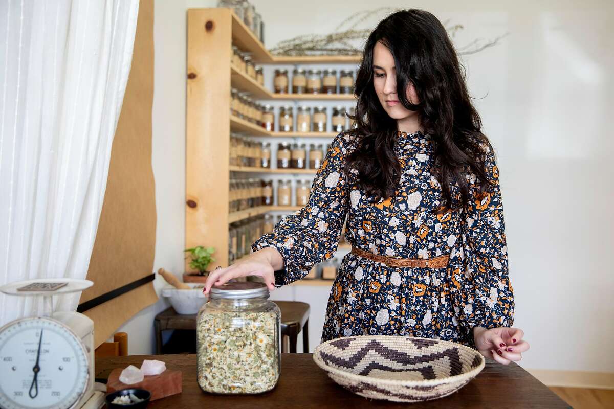 Erin Wilkins organizes herbs inside of her shop Herb Folk in Petaluma, Calif.
