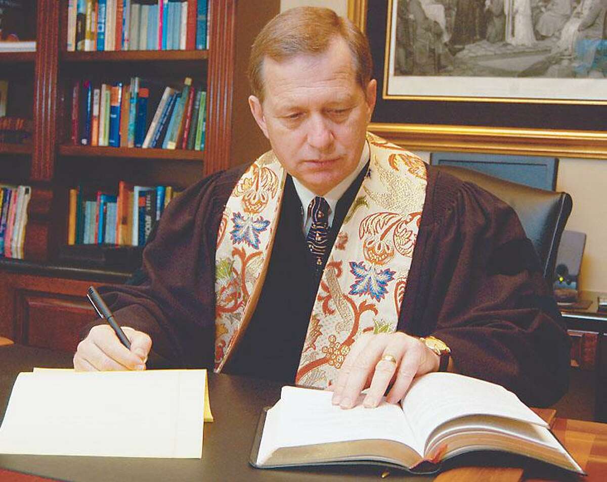 The Rev. Ed Robb, pastor of The Woodlands United Methodist Church works at his desk in 2003.