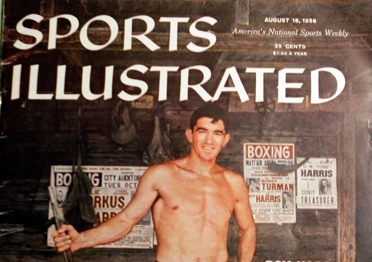 A copy of Sports Illustrated August 18, 1958 magazine cover is shown featuring boxer Roy Harris of Cut and Shoot. Roy Harris, who in addition to being a boxing legend, served as Montgomery County clerk for 28 years.