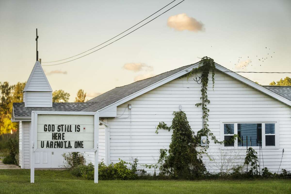 The sign in front of Sanford First Baptist Church reads, "God still is here, you are not alone," Sept. 3, 2020 in Sanford. (Katy Kildee/kkildee@mdn.net)
