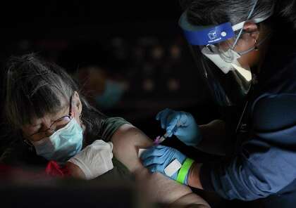 C. Terrell, of Webster, Texas gets her COVID-19 vaccine at Minute Maid Park in Houston on Saturday, Jan. 16, 2021. The mega-distribution site administered 5000 COVID vaccines on Saturday.