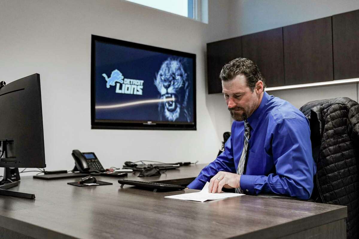 In this image provided by the Detroit Lions, Detroit Lions head coach Dan Campbell sits in his office on his first day at the NFL football team's practice facility, Thursday, Jan. 21, 2021 in Allen Park, Mich. (Detroit Lions via AP).