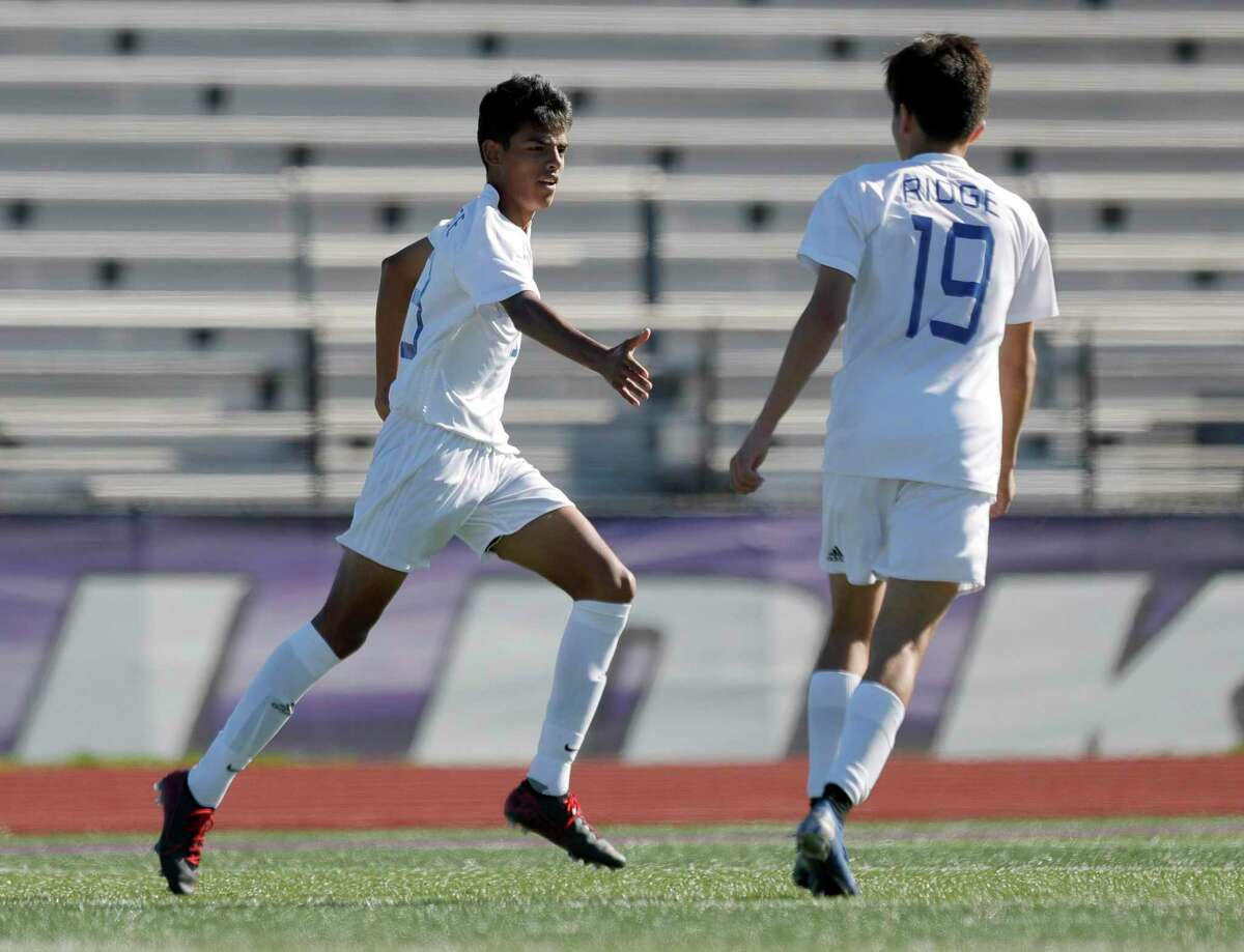 FILE PHOTO — Oak Ridge’s Jair Alvarez (13) gets a high-five from Allen Jaimes (19) after scoring a goal in the first period of a high school soccer match during the Wildkat Showcase, Saturday, Jan. 4, 2020, in Willis.