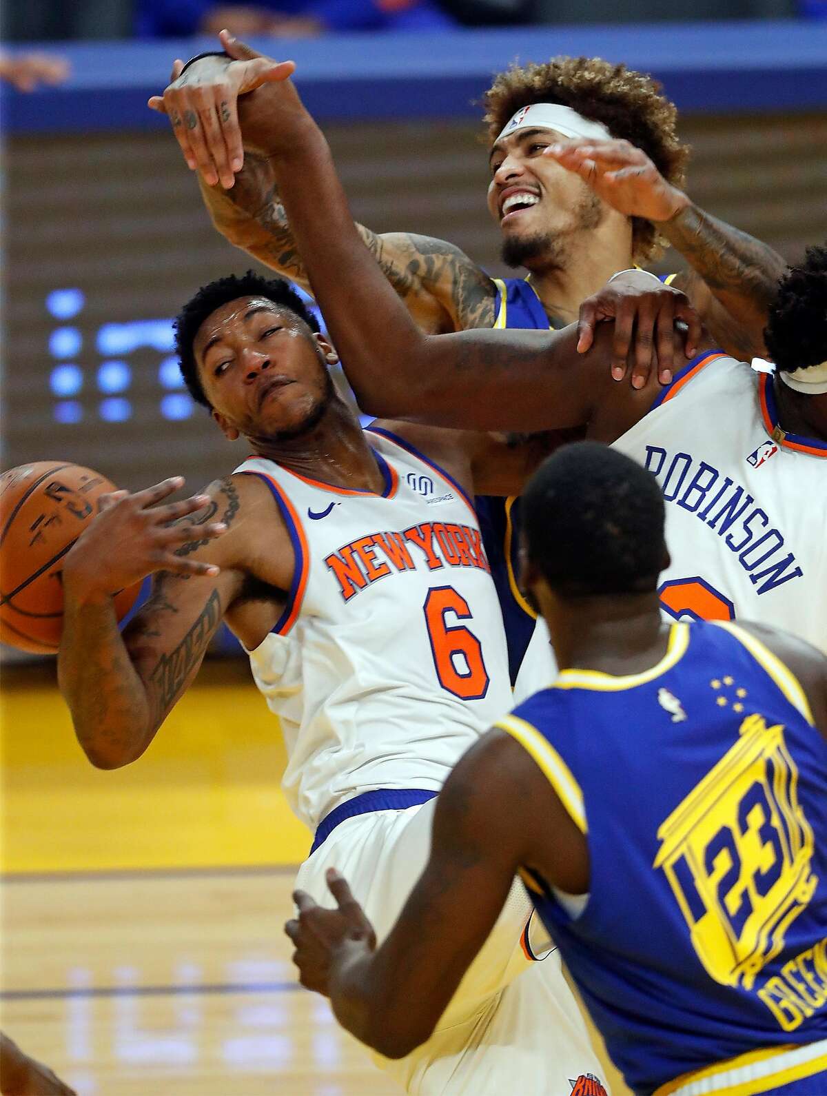 Golden State Warriors' Kelly Oubre, Jr. and New York Knicks' Elfrid Payton vie for a rebound in 1st quarter during NBA game at Chase Center in San Francisco, Calif., on Thursday, January 21, 2021.