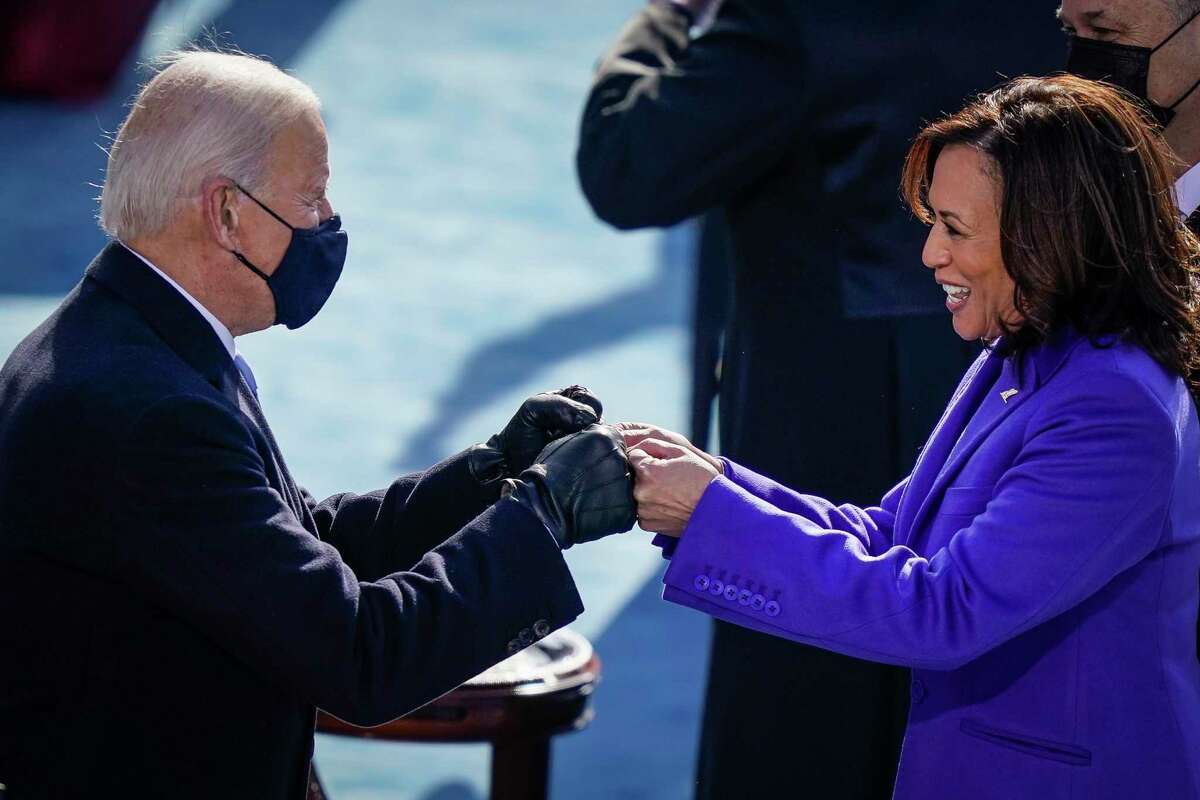 President Joe Biden bumps fists with Vice President Kamala Harris at Wednesday’s inauguration. It was a dark scene, but from the darkness can be seen glimmers of hope for Biden and the nation.