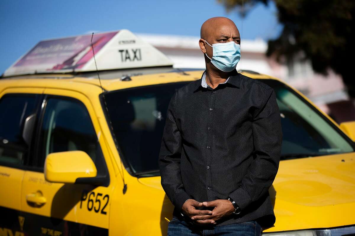 Yoseph Awoke with his taxi in Oakland Thursday. He’s been struggling since the start of the coronavirus pandemic, as fewer people take public transportation and taxis.