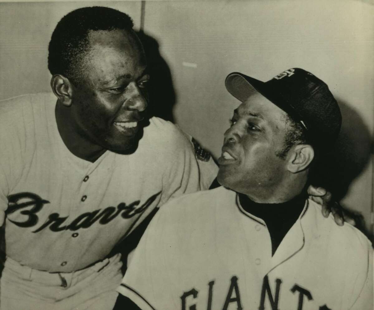 Baseball. Hank Aaron. San Francisco--A Look Over The Shoulder--Willie Mays, right, San Francisco Giants, looks over his shoulder at smiling Hank Aaron of the Atlanta Braves in the clubhouse before last night's game. Mays has a lifetime total of 608 home runs, second only to Babe Ruth's 714. Aaron, who has hit 16 this year, has a total of 570. He also got his 3,000th hit last Sunday against Cincinnati. Mays has 8 home runs to date this year.