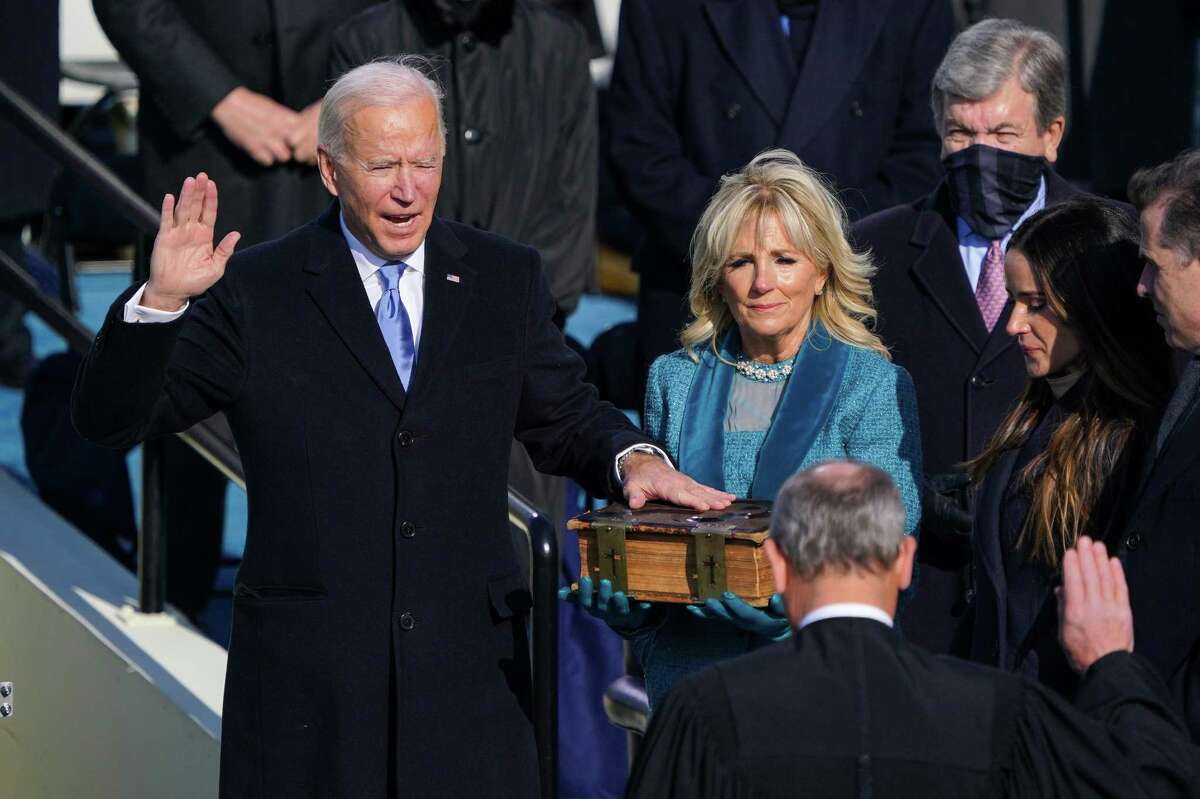 Chief Justice John Roberts swears in Joe Biden as the 46th President of the United States, as his wife Jill Biden holds a Bible at the Capitol in Washington on Wednesday, Jan. 20, 2021. (Chang W. Lee/The New York)