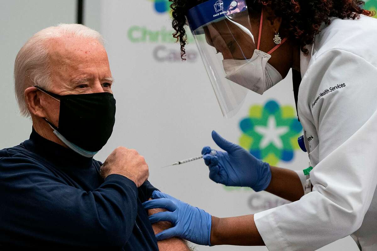 President-elect Joe Biden - wearing two masks - receives a COVID-19 vaccination from nurse practitioner Tabe Mase in Newark, Del., last month.