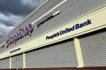 A People's United Bank sign displayed outside of the Stop & Shop in Milford on Friday.