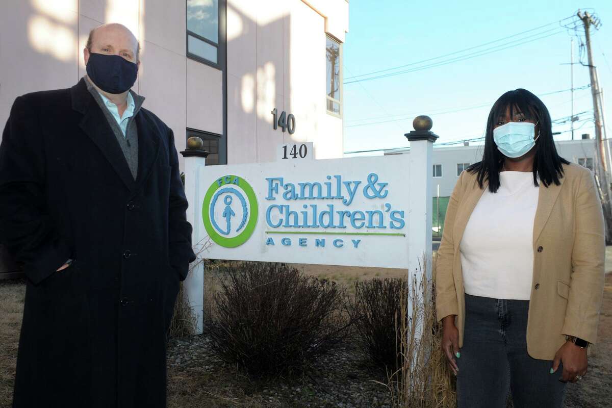Chris Jachino, Director of Homeless Services and Lorraine Reid-James, CAN Manager for Minors, pose in front of The Family and Children's Agency, in Norwalk, Conn. Jan. 22, 2021.