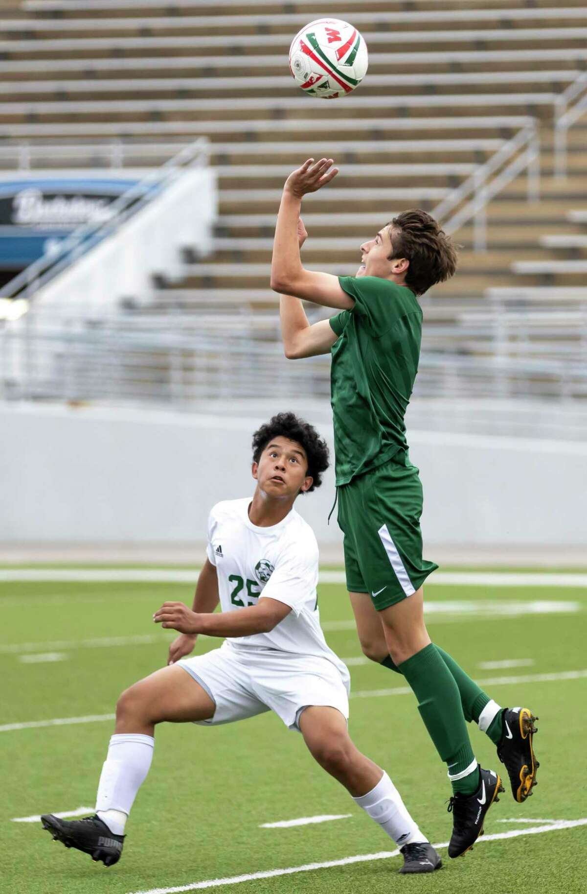 The Woodlands midfielder Andy Davison (5) attempts to take control of the ball while under pressure from Klein Forest’s Joshua Reyes (25) during the first half of a Highlander Invitational soccer match at Woodforest Bank Stadium, Friday, Jan. 22, 2021, in Shenandoah.