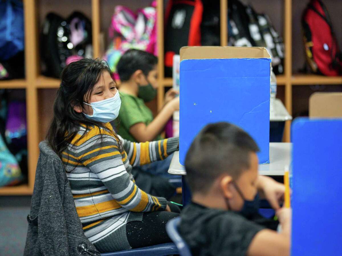 Miranda Zertuche, bottom right, and her fellow bilingual third grade classmates take a test at Calder Road Elementary on Friday, Jan. 15, 2021, in Dickinson, Texas. More than 40,000 students have opted to return to campuses for instruction despite a surge in COVID-19 infections. In Dickinson ISD, 93 percent of students are back in their classrooms.