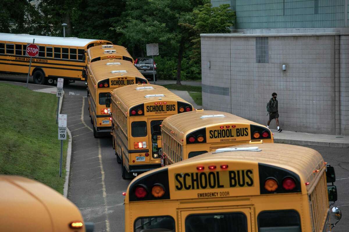 STAMFORD, CONNECTICUT - SEPTEMBER 14: Busses depart after dropping off students at Rippowam Middle School on September 14, 2020 in Stamford, Connecticut. Most students there are taking part in a hybrid model, where they attend in-school classes every other day and distance learn the rest. More than 20 percent of students in the Stamford Public Schools district are enrolled in the distance learning option only, due to coronavirus concerns. (Photo by John Moore/Getty Images)