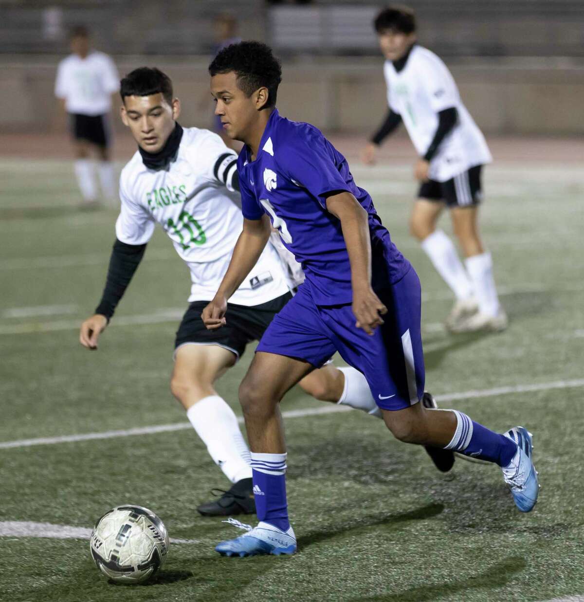 Humble midfielder Josue Zapata (5) drives the ball while under pressure from Pasadena Ruben Rodriguez (10) during the first half of a non-district soccer match at George Turner Stadium, Tuesday, Jan. 19, 2021, in Humble.