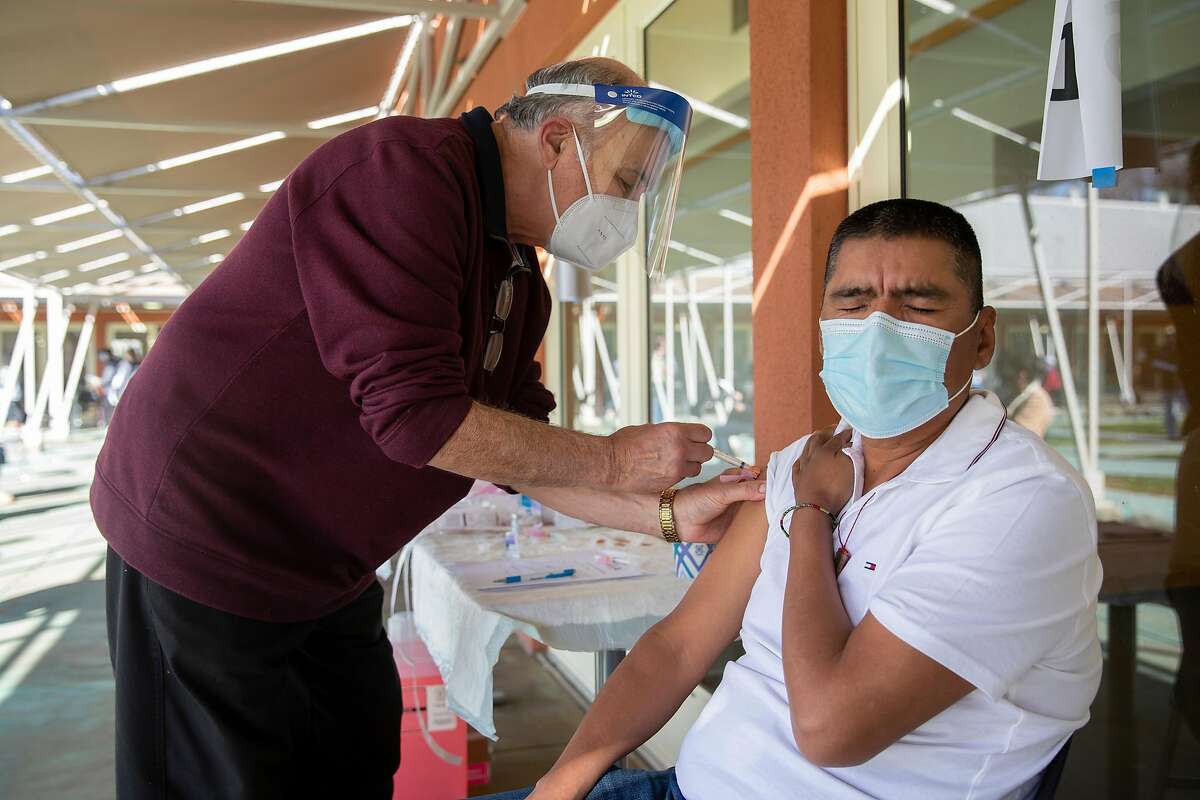 Dr. Joseph Aita administers a COVID-19 vaccination to Carlos Tiburcio, a worker with Renteria Vineyards.