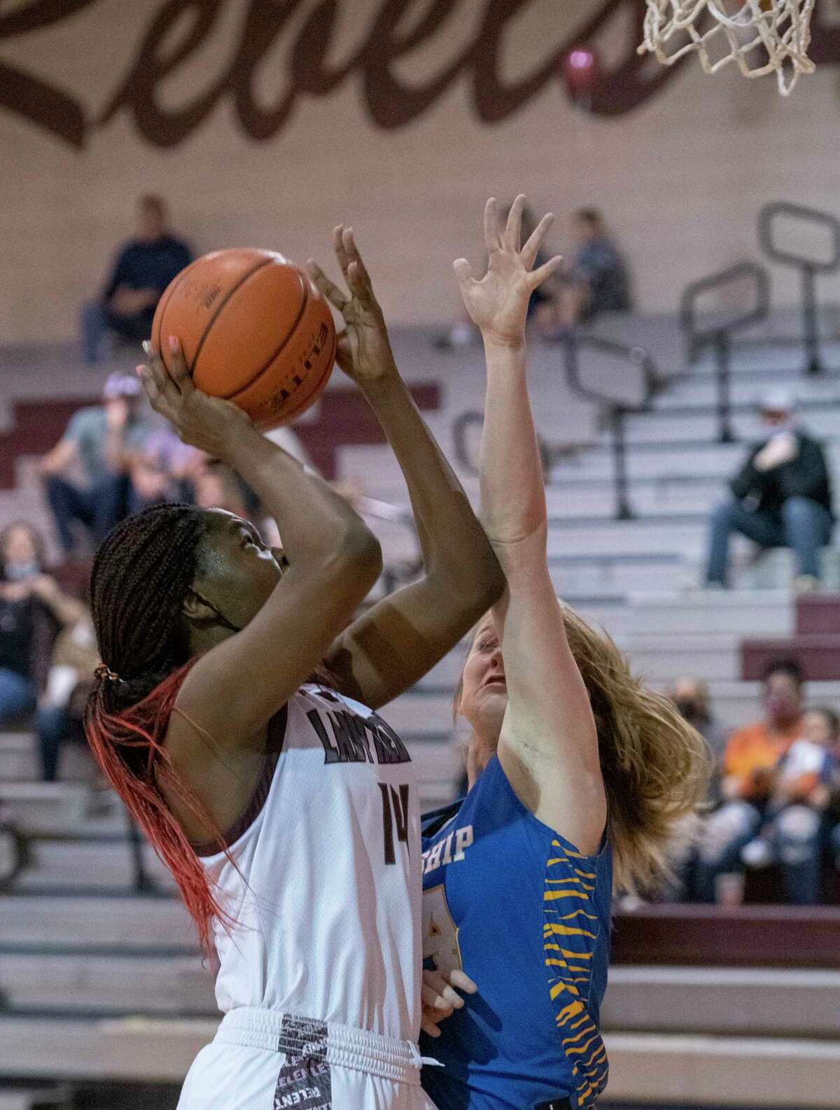 Lee High's Loredona Fouonji puts up a shot as Frenship's Addison McClure defends 01/22/2021 at the Lee High gym. Tim Fischer/Reporter-Telegram
