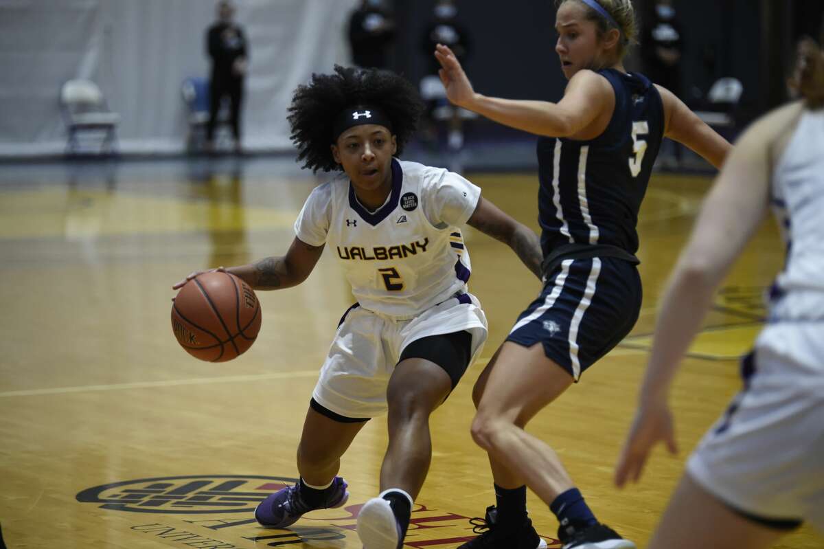 UAlbany's Kyara Frames drives around New Hampshire's Amanda Torres in an America East women's basketball game Saturday, Jan. 23, 2021, at SEFCU Arena in Albany. (Kathleen Helman/UAlbany athletics)