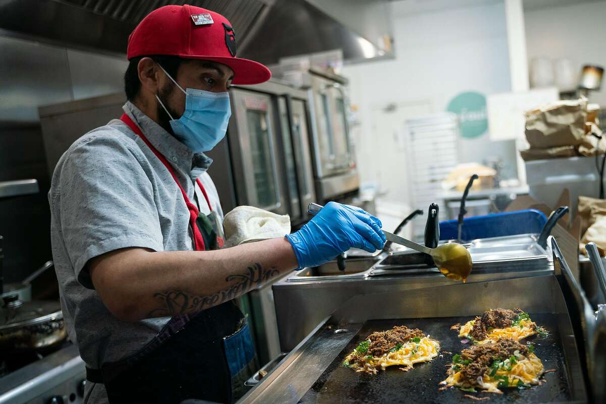 Jorge Islas prepares an order of the popular quesabirrias at Frank Grizzly’s Kitchen in San Francisco.
