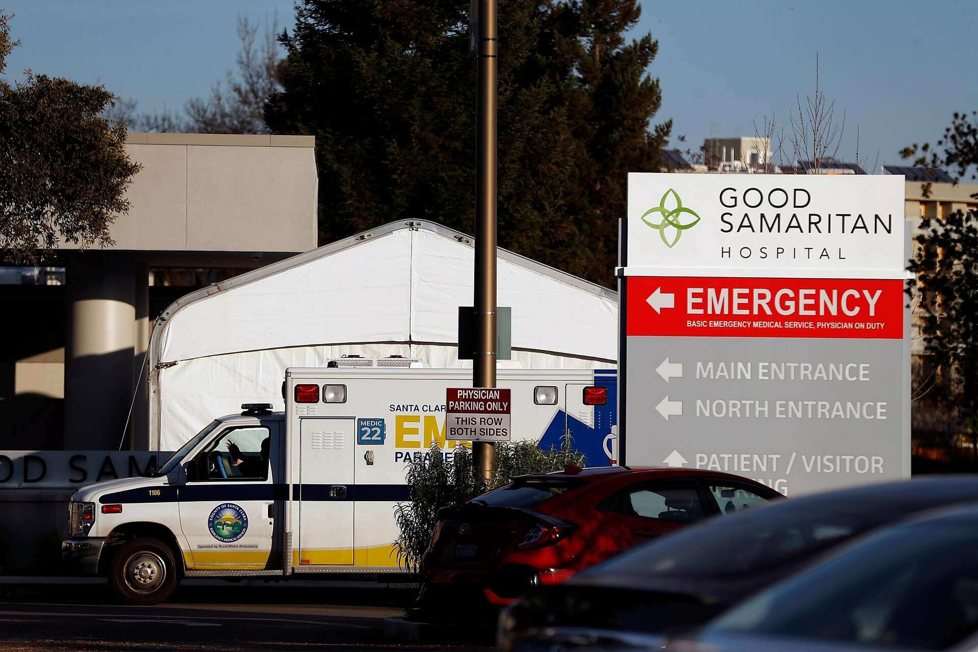 An ambulance waits outside the emergency room entrance at Good Samaritan Hospital in San Jose, Calif., on Thursday, Jan. 7, 2021.