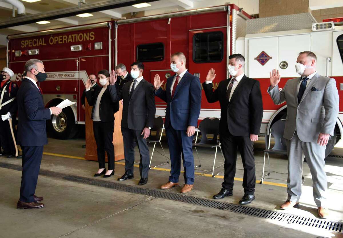 First Selectman and Fire Commissioner Fred Camillo swears in new fire department recruits, from left, Jennifer Osher, Joseph Battinelli, Ryan Crook, Scott Lanahan, and Tim Lewis, at the Greenwich Fire Department swearing-in ceremony at the Public Safety Complex in Greenwich, Conn. Monday, Jan. 25, 2021.