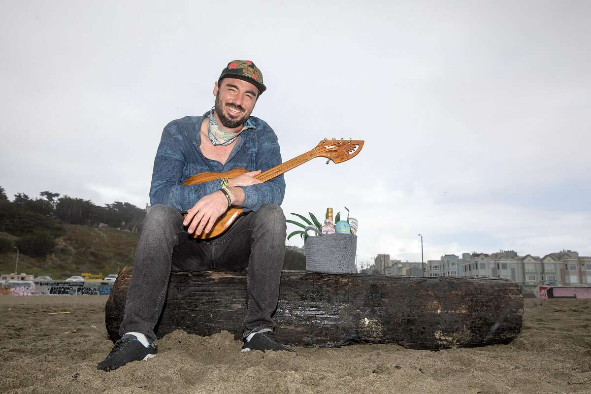 Joshua James plays a ukulele at Ocean Beach in San Francisco, California on Jan. 25, 2021. He just opened up Ocean Beach Cafe a block away from Ocean Beach.