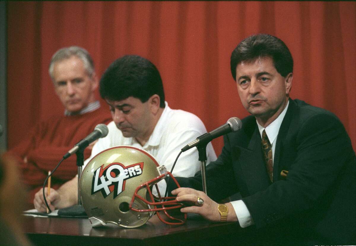 San Francisco 49ers owner Edward J. DeBartolo, Jr. (left) introduces the new club president, Carmen Policy, to reporters on Feb. 13, 1991. The 49ers also took the opportunity to unveil their new helmet with a new “49ers” logo.